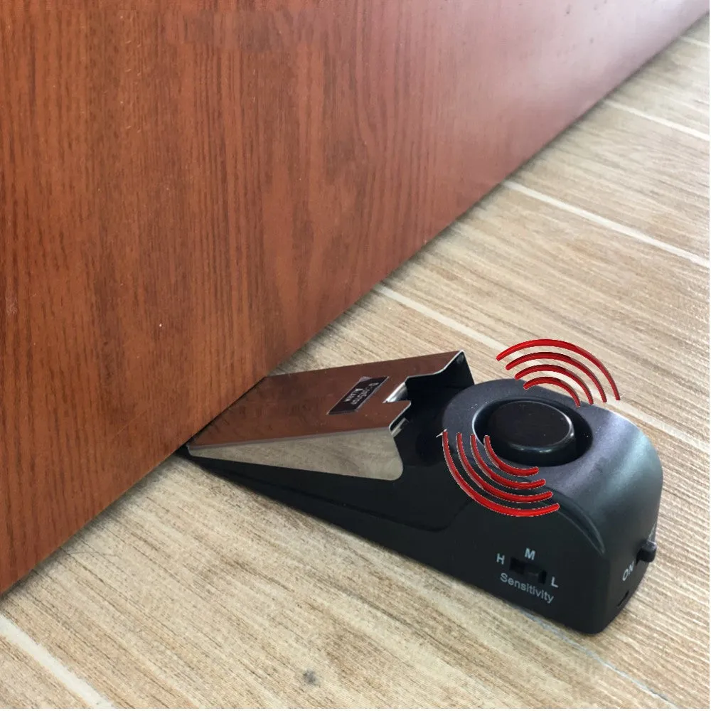 Black 120dB door stop alarm with stainless steel cover and wedge shape, measuring 14cm long