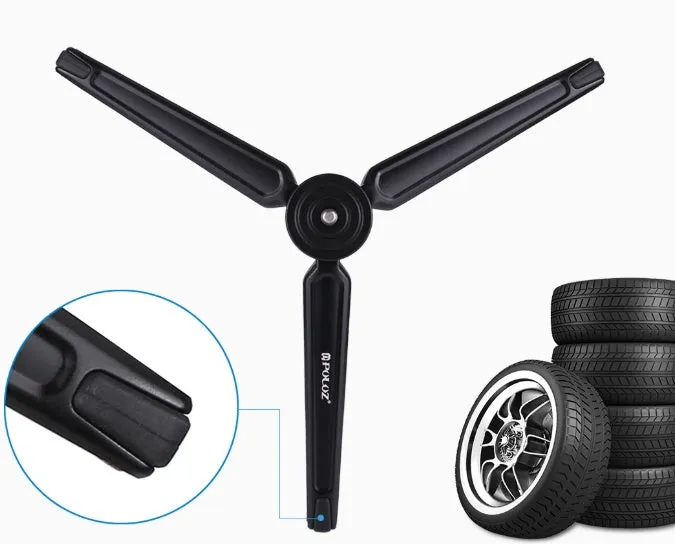 Metal mini tripod with non-slip rubber feet, 15cm max height, black, on uneven outdoor surface