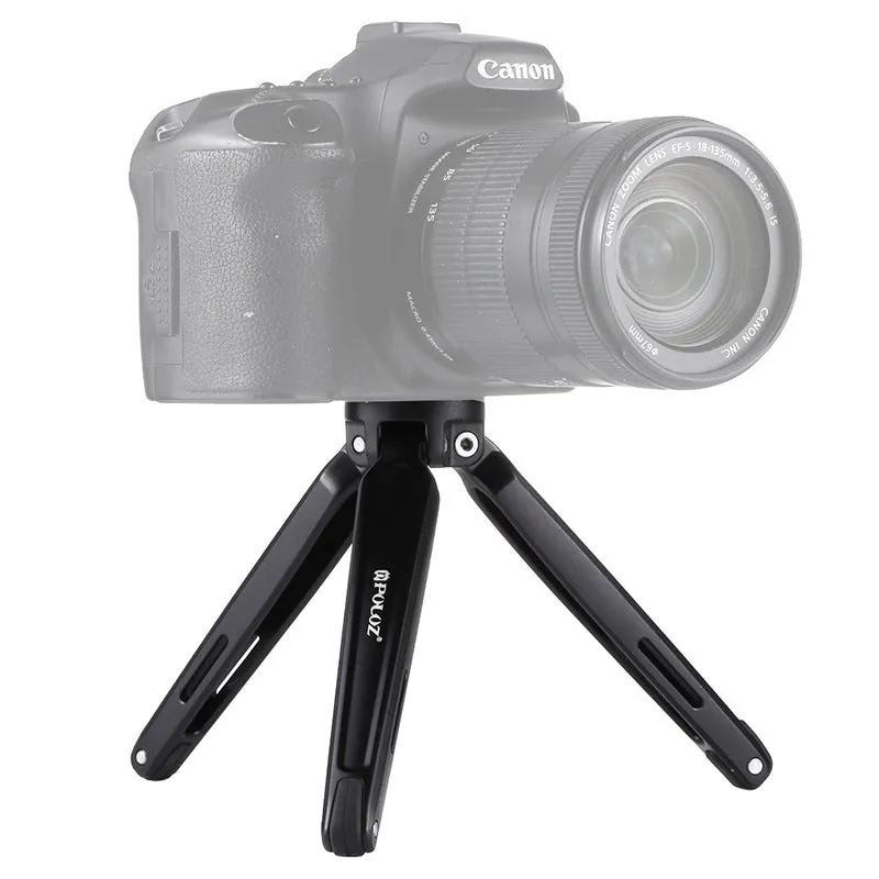 Metal mini tripod with non-slip rubber feet, 15cm max height, black, on uneven outdoor surface