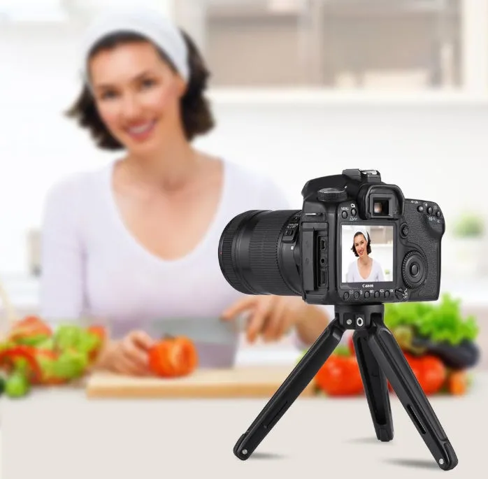 Metal mini tripod with non-slip rubber feet, 15cm max height, black, on uneven outdoor surface