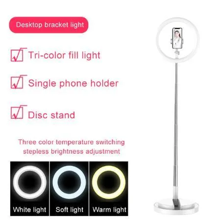 Portable 290mm LED selfie ring light in black on table, showing centre phone holder and adjustable brightness button