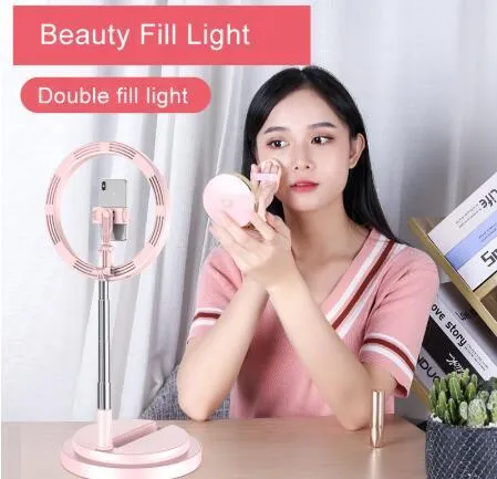 Portable 290mm LED selfie ring light in black on table, showing centre phone holder and adjustable brightness button