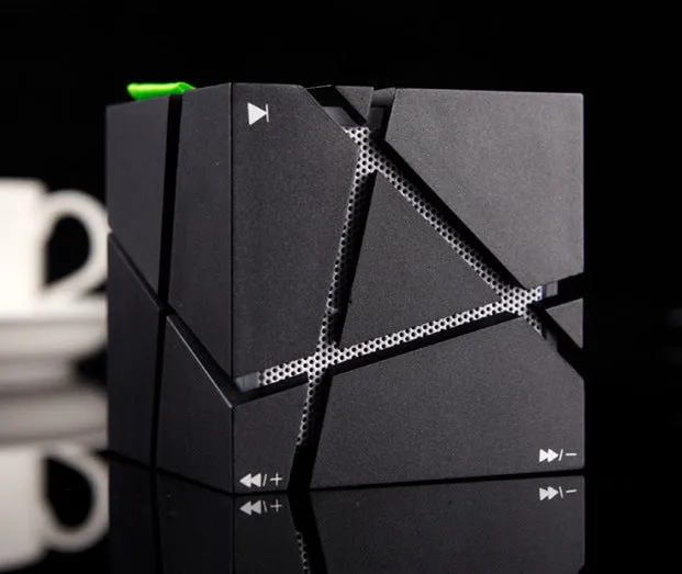 Cube Bluetooth Speaker with colourful lights in black ABS casing, front view on desk
