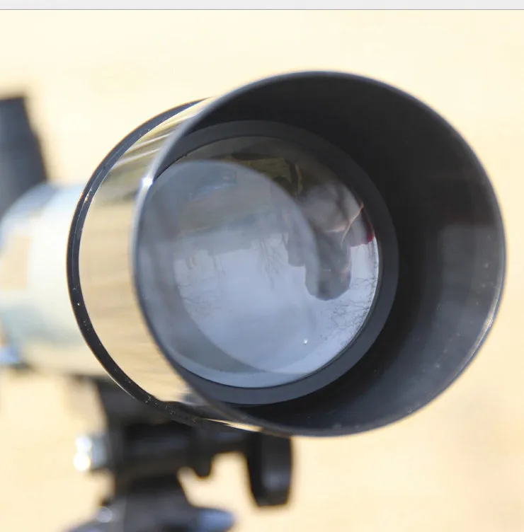 Silver telescope on aluminium tripod with multiple eyepieces and moon lens for stargazing