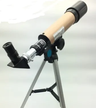 Silver telescope on aluminium tripod with multiple eyepieces and moon lens for stargazing