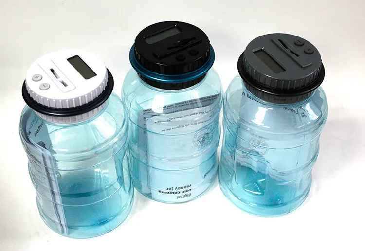 Transparent digital coin counting money box with LCD screen on lid, showing coin slot and clear jar body