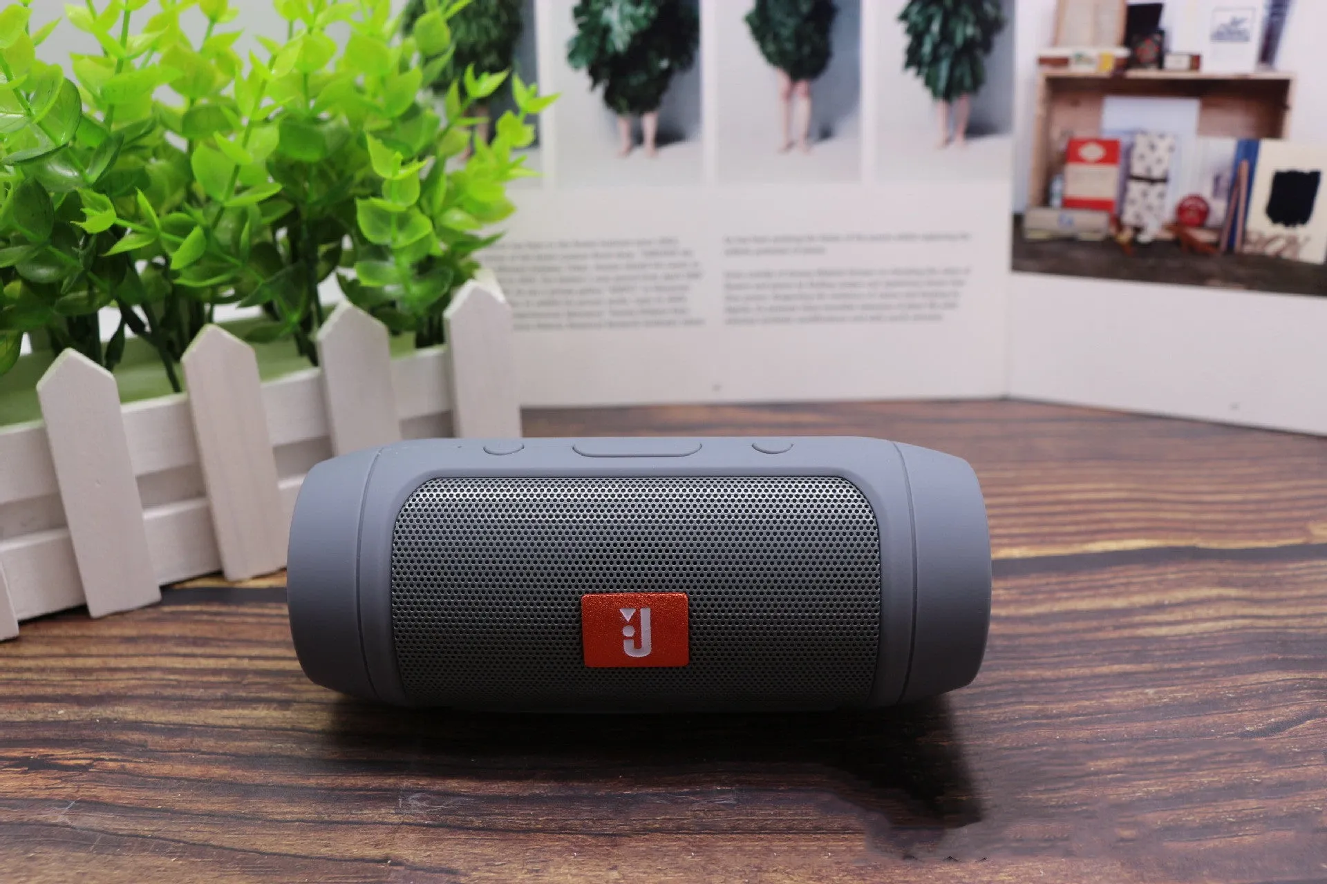 Waterproof Bluetooth speaker in black with USB charging port and control buttons