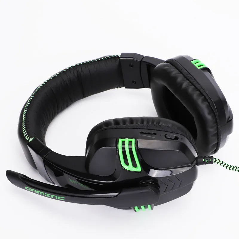 Black wired gaming headset with microphone placed on a desk, 3.5mm plug visible