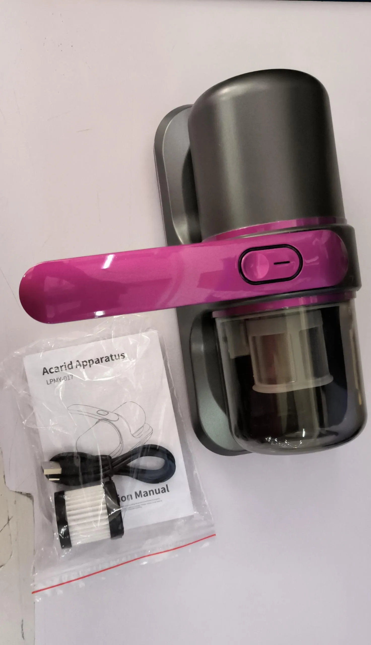 Blue home mite removal instrument with UV sterilization and wireless vacuum cleaner on a bed