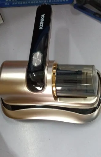 Blue home mite removal instrument with UV sterilization and wireless vacuum cleaner on a bed