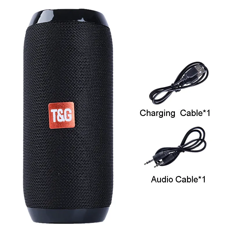 Black portable IPX5 waterproof Bluetooth speaker with mesh grille on a rocky outdoor surface