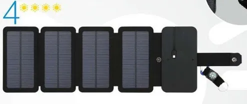 Black folding solar panel charger with monocrystalline cells and USB output, folded flat on a wooden surface, compass buckle visible
