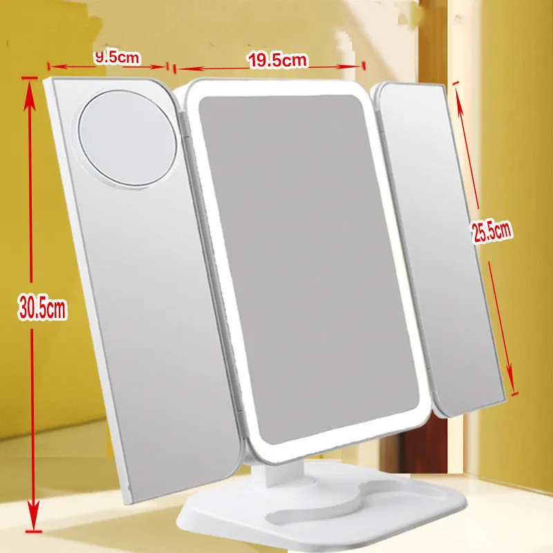 Trifold LED makeup mirror with 68 lights, 10X detachable magnifier, silver surface, rotating 180 degrees on a tabletop