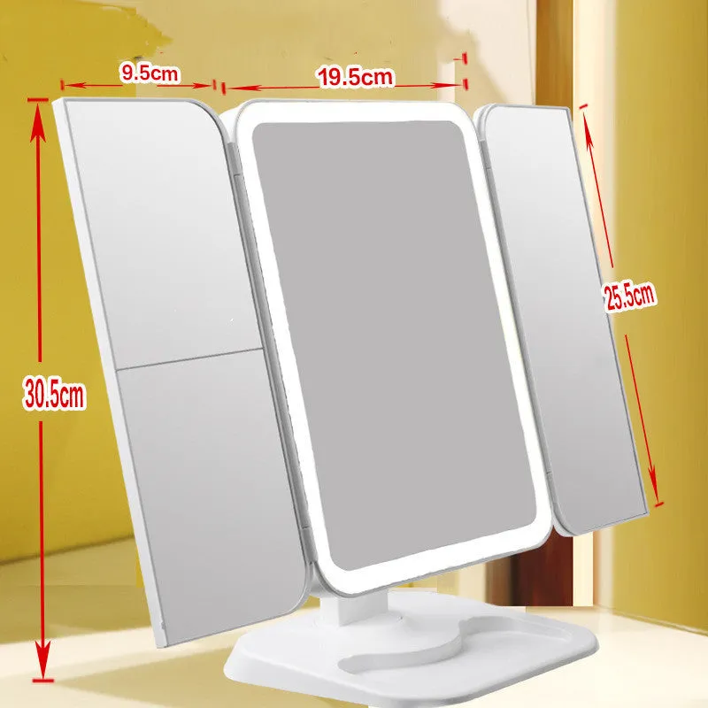 Trifold LED makeup mirror with 68 lights, 10X detachable magnifier, silver surface, rotating 180 degrees on a tabletop