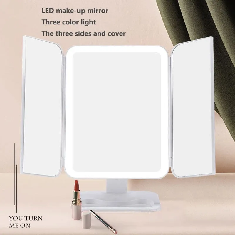 Trifold LED makeup mirror with 68 lights, 10X detachable magnifier, silver surface, rotating 180 degrees on a tabletop