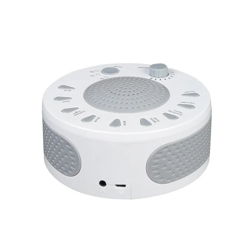 White portable white noise sleep sound machine with control knob on a bedside table.