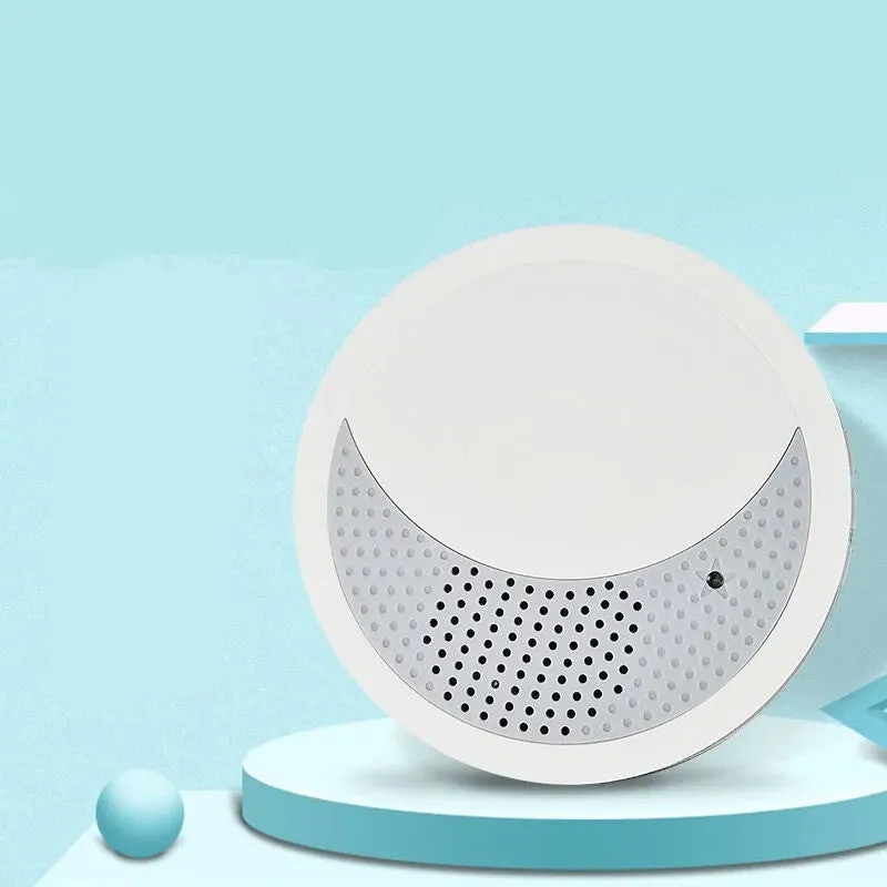 White portable white noise sleep sound machine with control knob on a bedside table.
