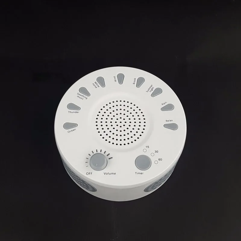 White portable white noise sleep sound machine with control knob on a bedside table.