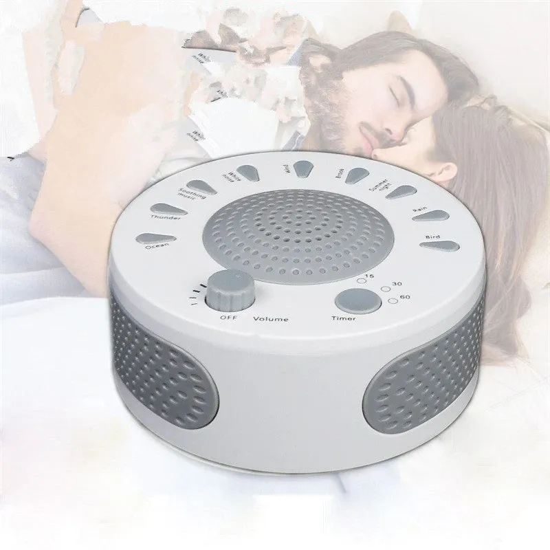 White portable white noise sleep sound machine with control knob on a bedside table.
