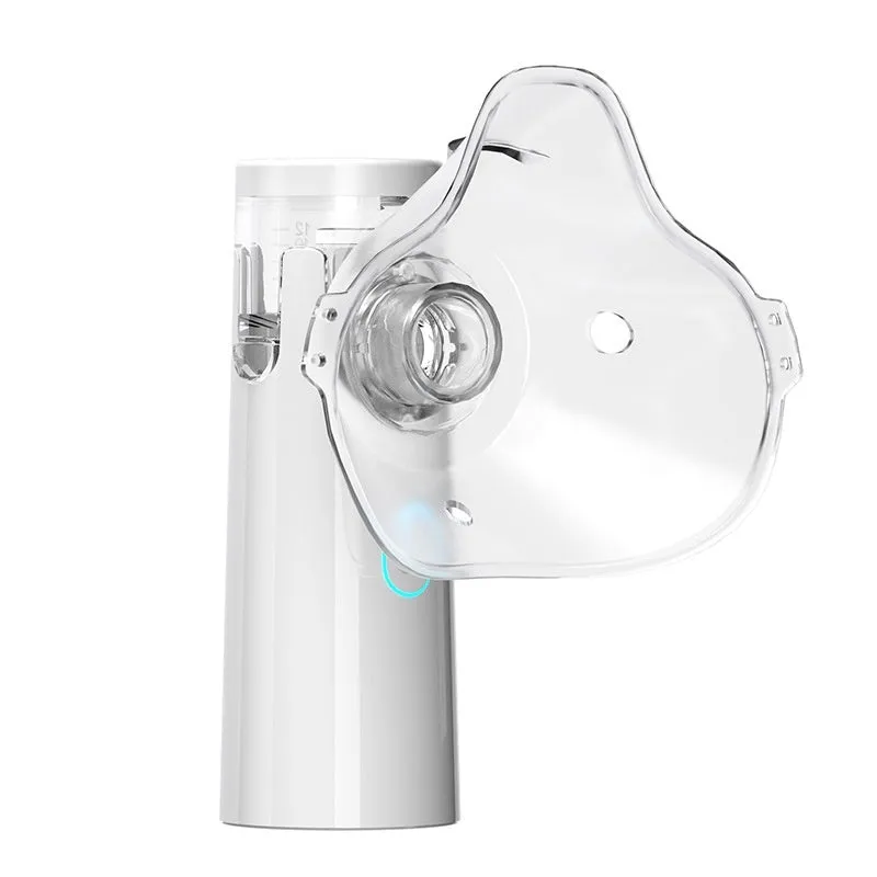 White neutral SY308 portable compressed micro-mesh nebulizer with bilateral masks and power cord on flat surface