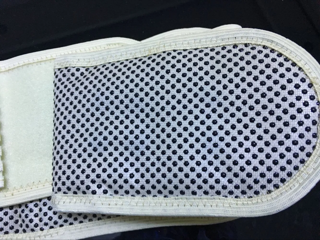 Black self-heating magnetic waist support belt for lumbar muscle strain, shown on a neutral background.