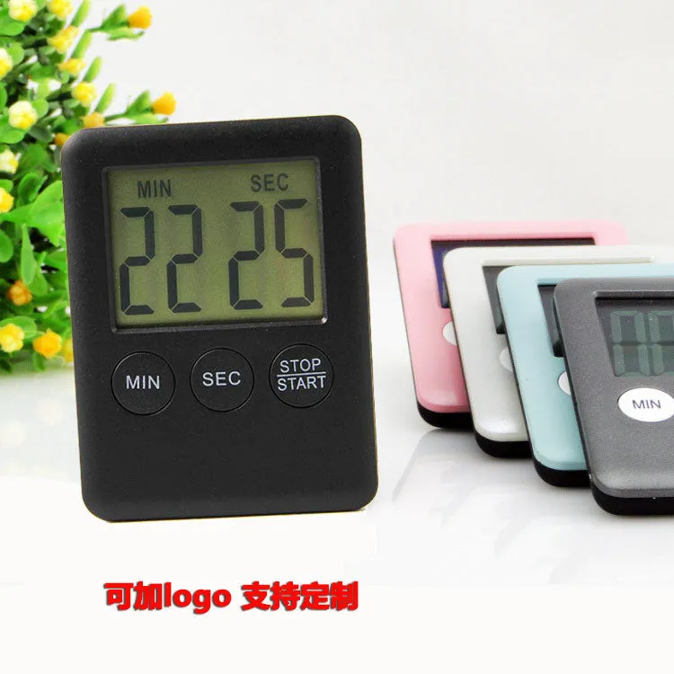 Black and white digital kitchen timer with magnetic back and LED display showing countdown time