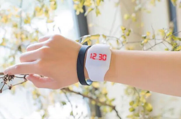 Square electronic touch screen watch with digital display on a PU strap, shown in multiple colour options.