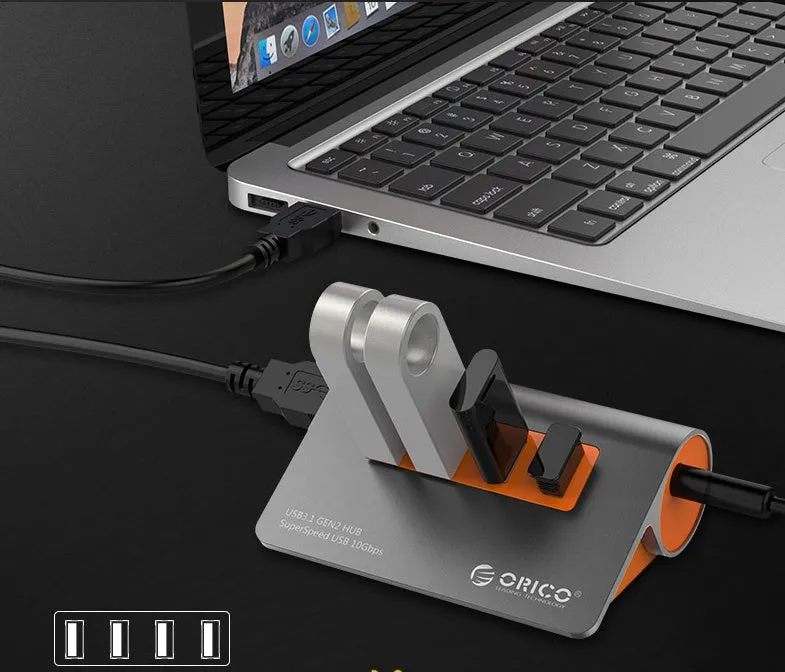 Dark grey and orange aluminium USB 3.1 laptop hub with four ports and separate 100cm cable