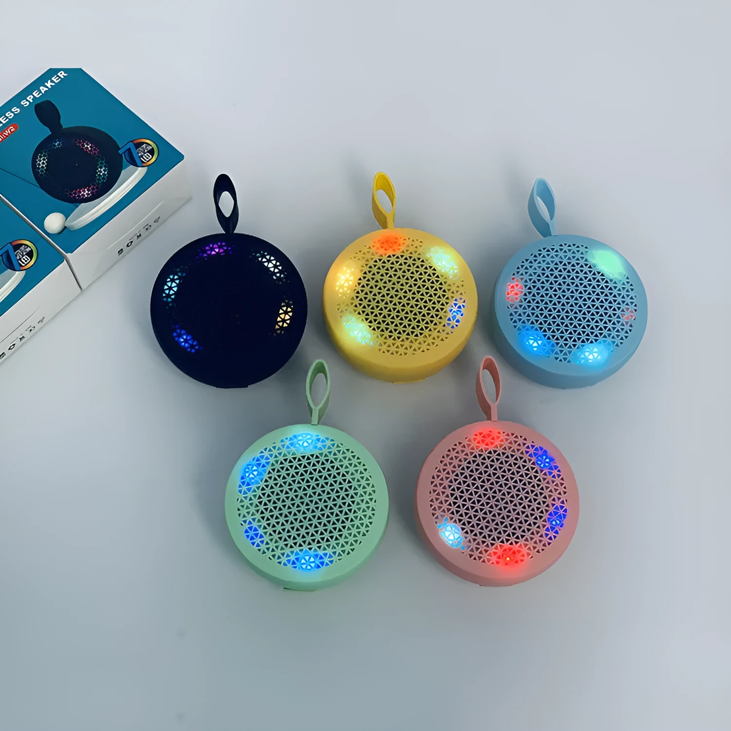 Pink mini Bluetooth speaker with plastic shell and button controls, 82x82x40mm
