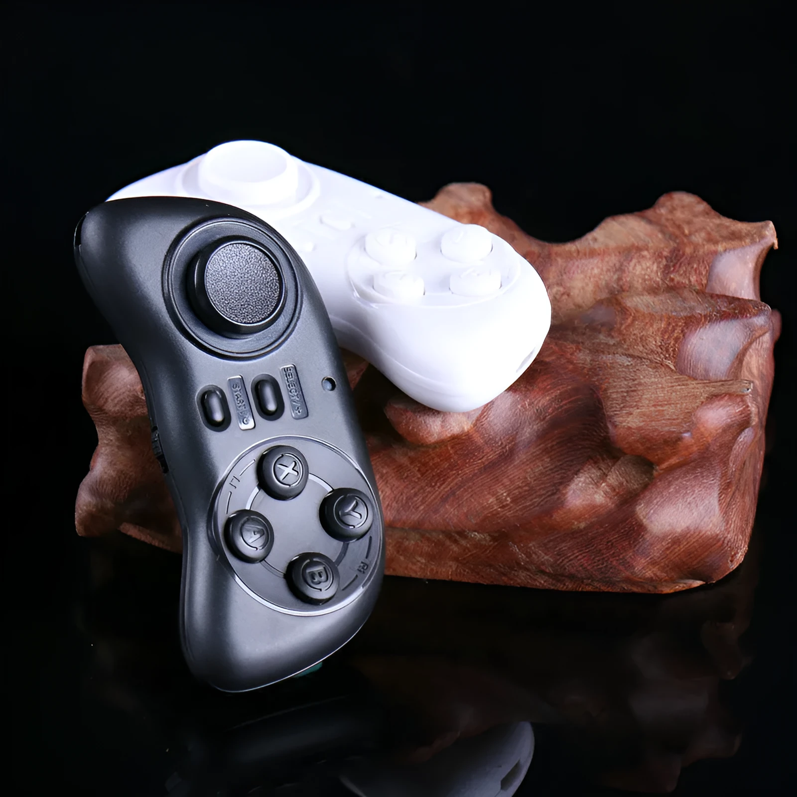 Black mobile game controller Smart Handle 608 on white background, Bluetooth mini gamepad with plastic body