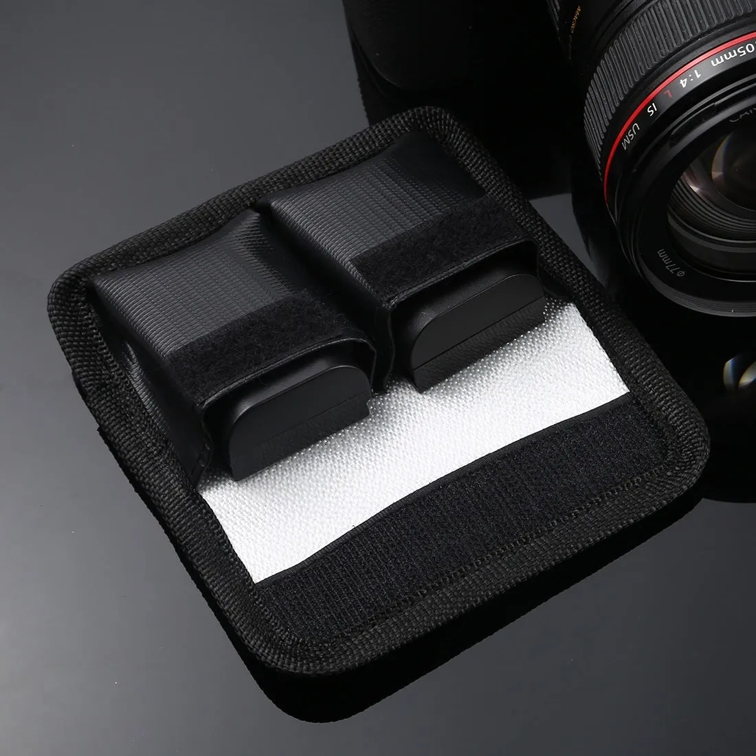 Black explosion-proof lithium battery storage bag with magic tape closure on a white background