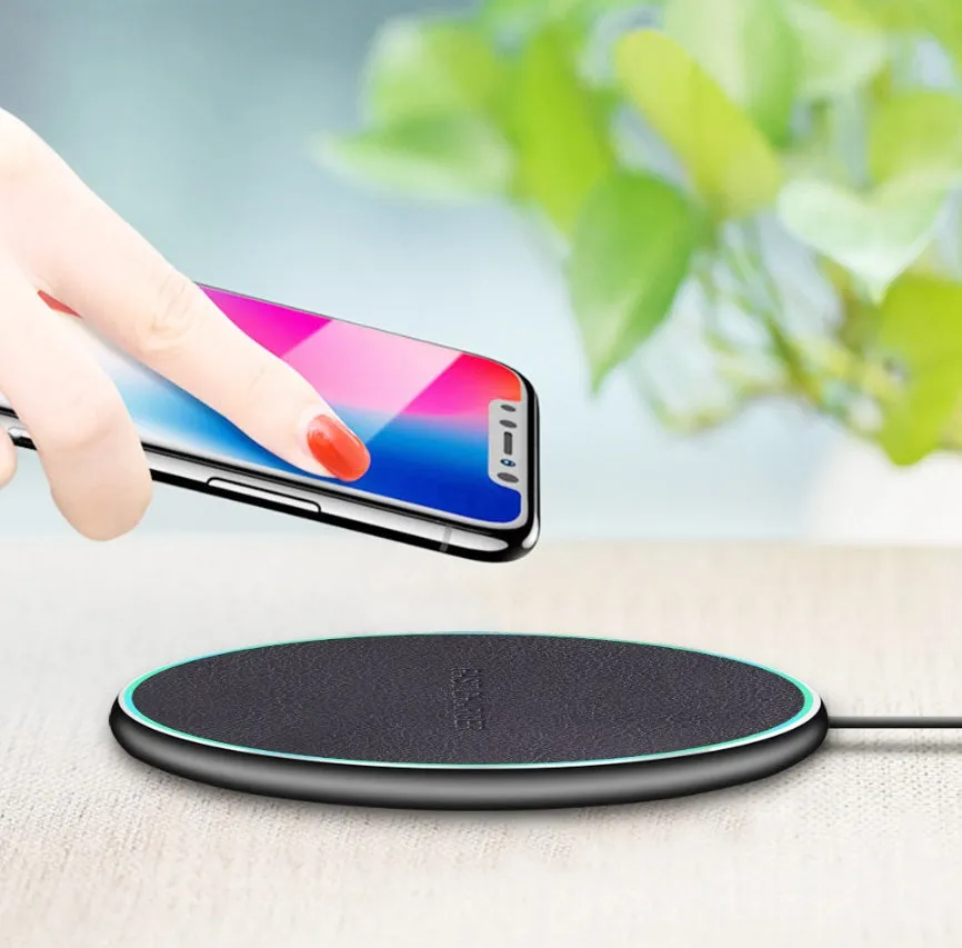 Black circular Qi wireless charging pad for iPhone 11 with LED light indicator