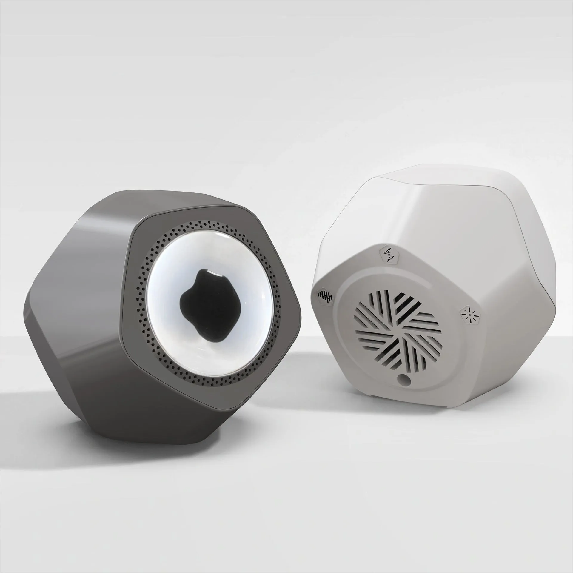 Floating magnetic fluid Bluetooth speaker in silver gray on a desktop, with magnetic fluid swirling inside the chamber