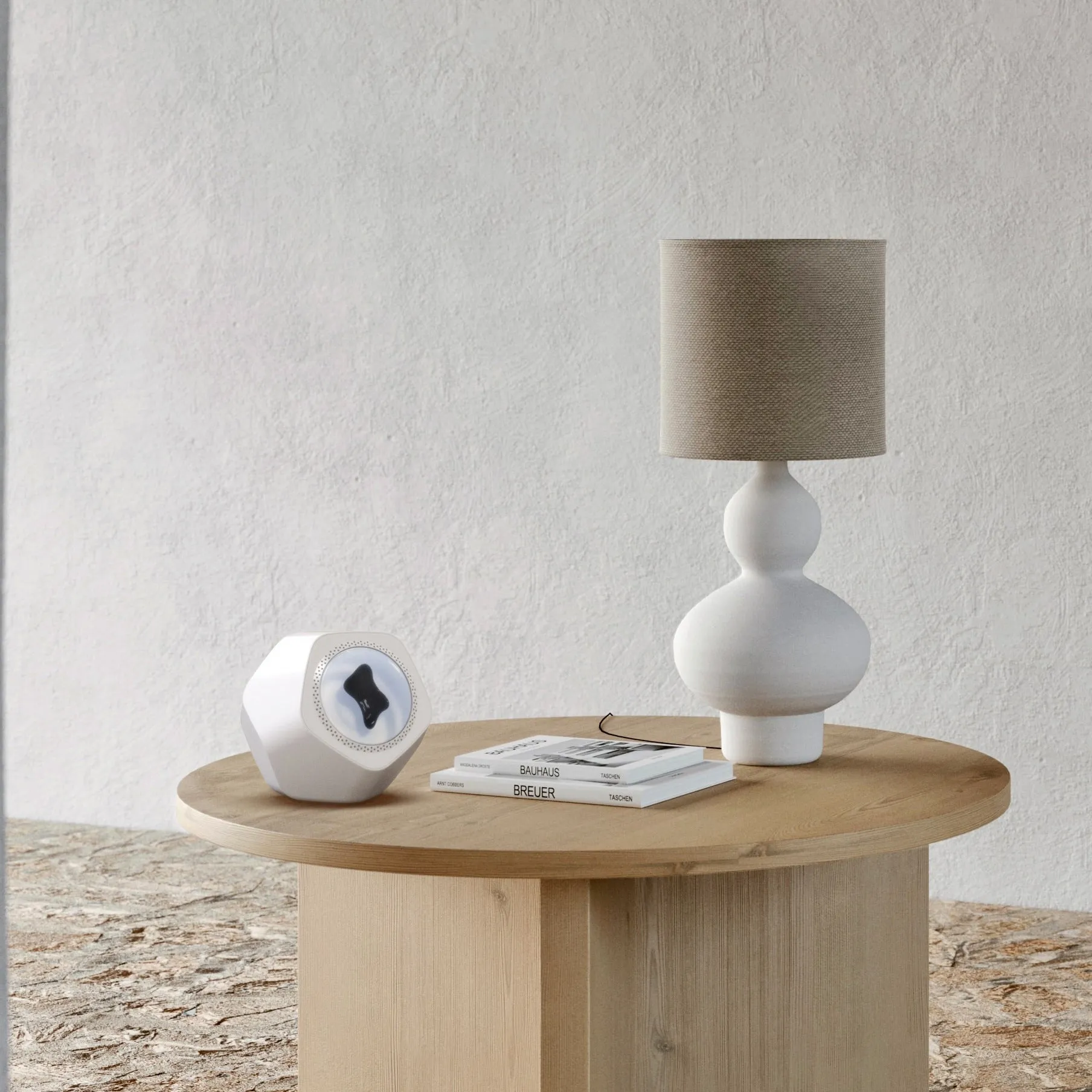 Floating magnetic fluid Bluetooth speaker in silver gray on a desktop, with magnetic fluid swirling inside the chamber