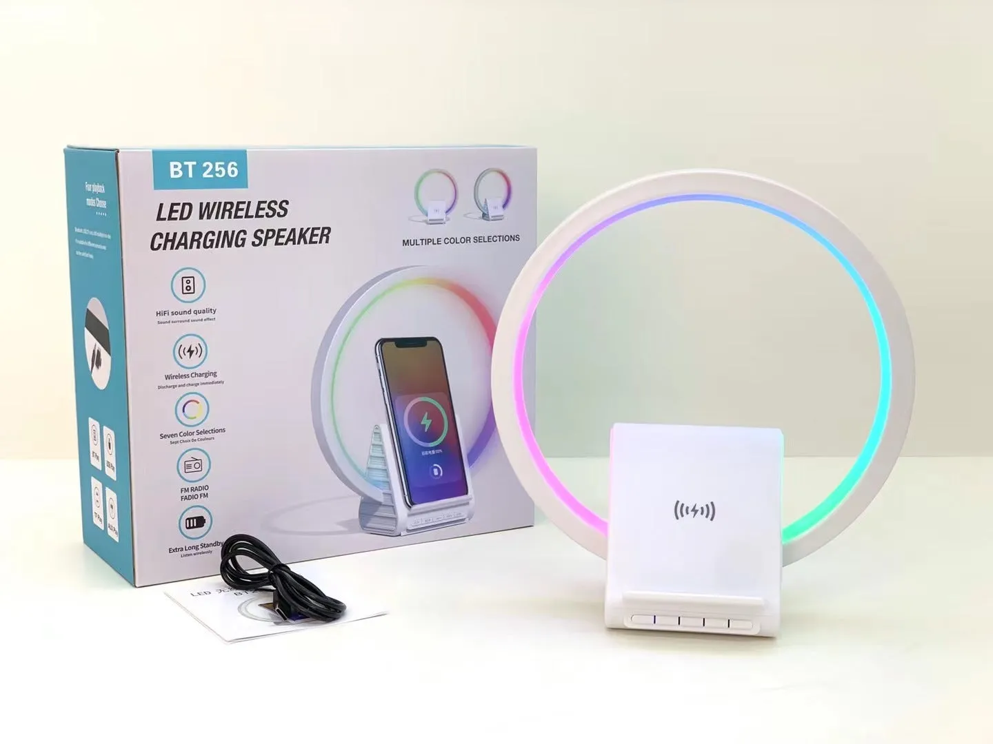White rectangular 15W wireless charging pad with integrated Bluetooth speaker and ambience light.