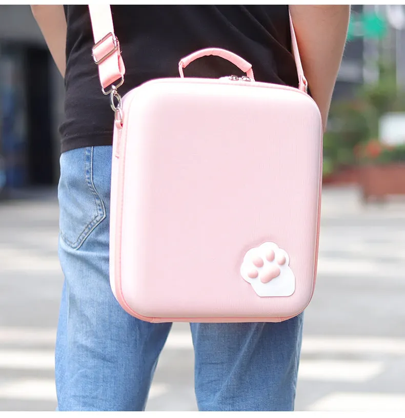 Pink Nintendo Switch storage bag with cat claw design, showing game cartridge slots and diagonal carry strap.