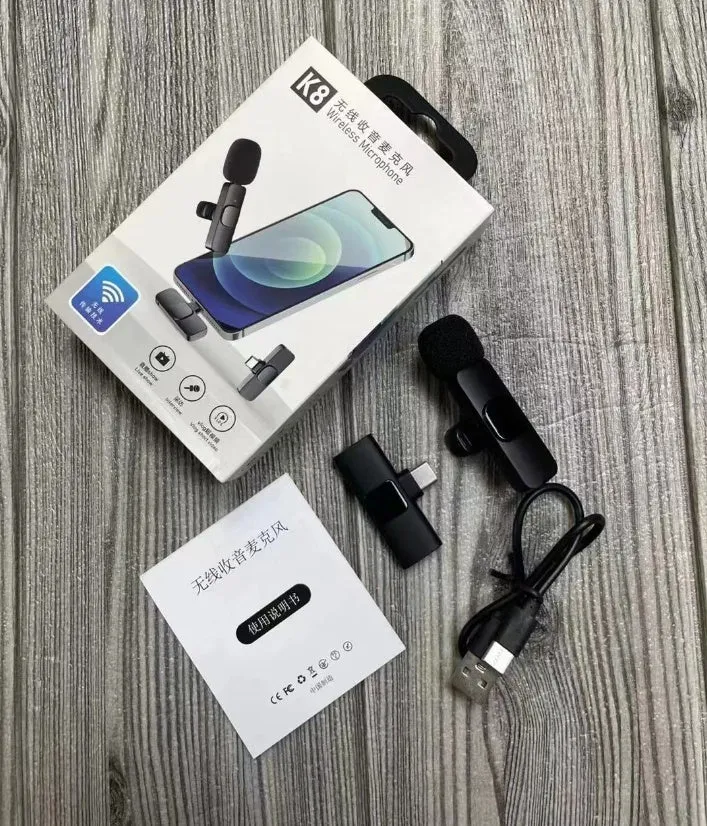 A wireless lavalier clip-on microphone attached to a shirt collar for hands-free video recording.