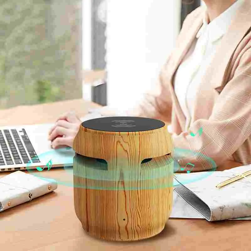 Wood grain wireless Bluetooth speaker with built-in wireless charger on a desk, 80x75x75mm plastic cabinet