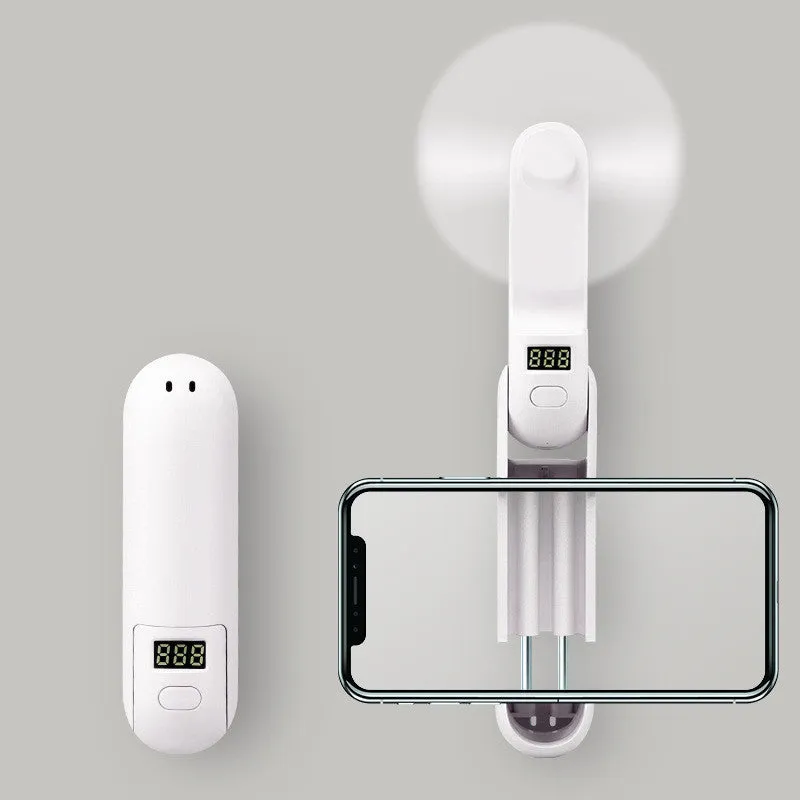 Green folding mini USB fan with plastic blades on a white background.