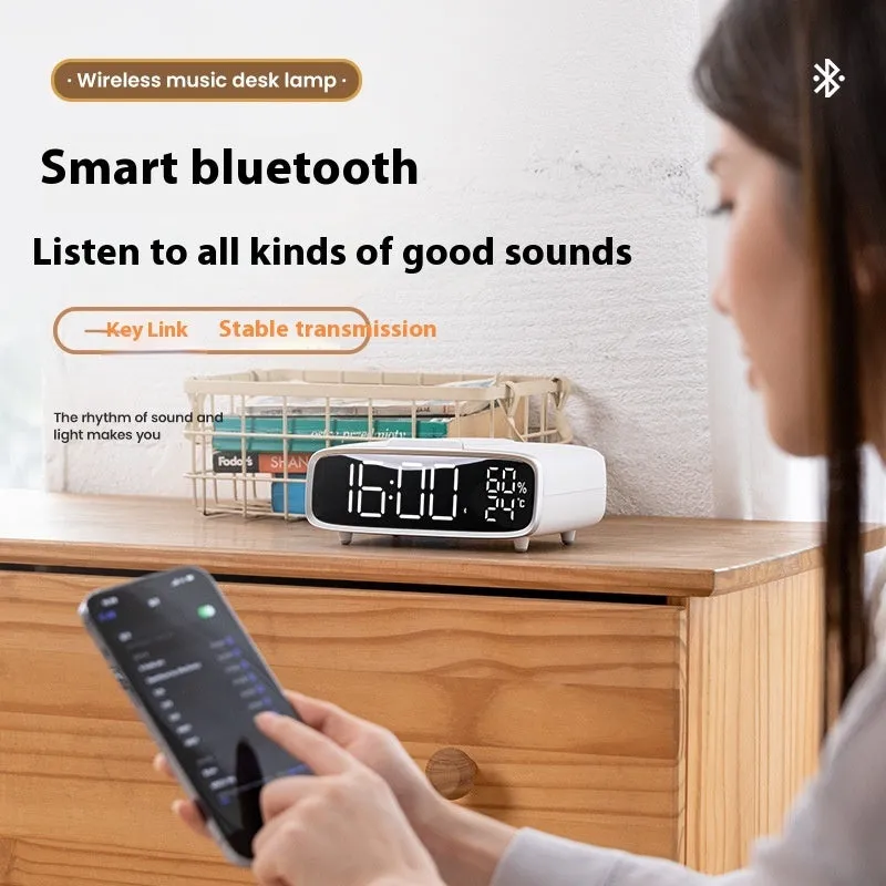White round Bluetooth speaker wireless charger alarm clock with night light on bedside table