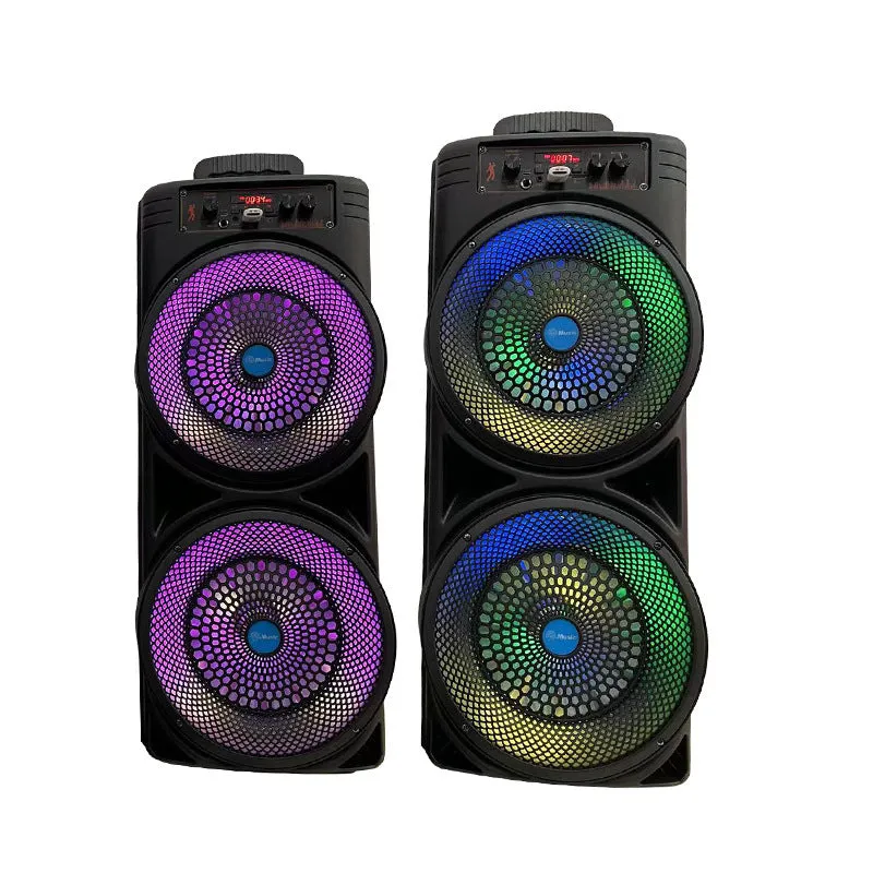 Black portable Bluetooth speaker with double 8-inch speakers, wired microphone, and remote control on a table