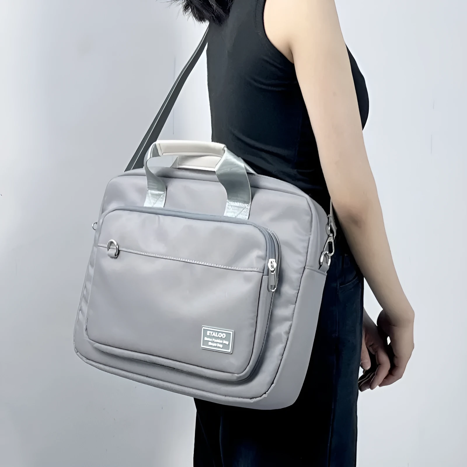 Oxford cloth laptop bag with shockproof air cushion pull rod belt in khaki colour placed on table