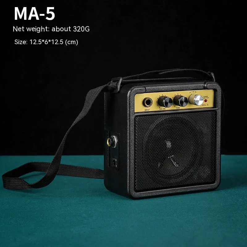Small and easy to carry guitar audio amplifier with metal plastic construction, 25 by 8 by 26 cm