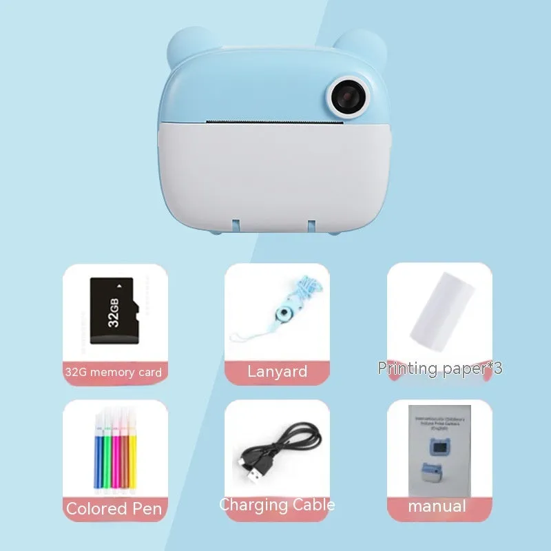Children's printing camera in pink with dual HD lenses, included crayons and printing paper on white background