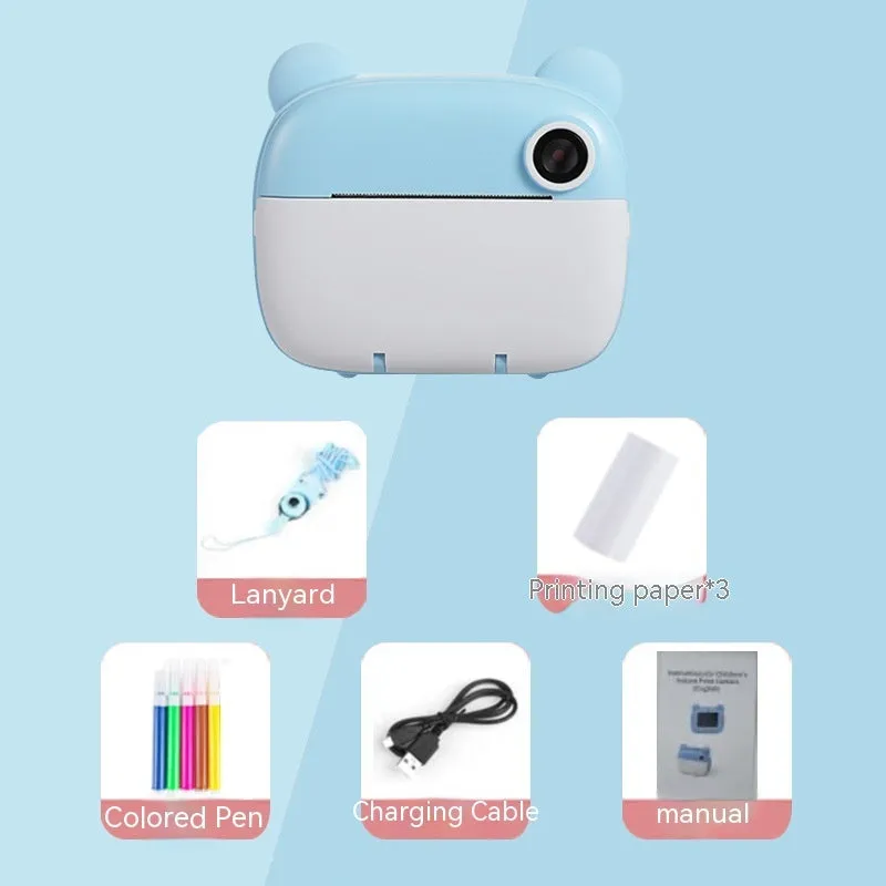 Children's printing camera in pink with dual HD lenses, included crayons and printing paper on white background