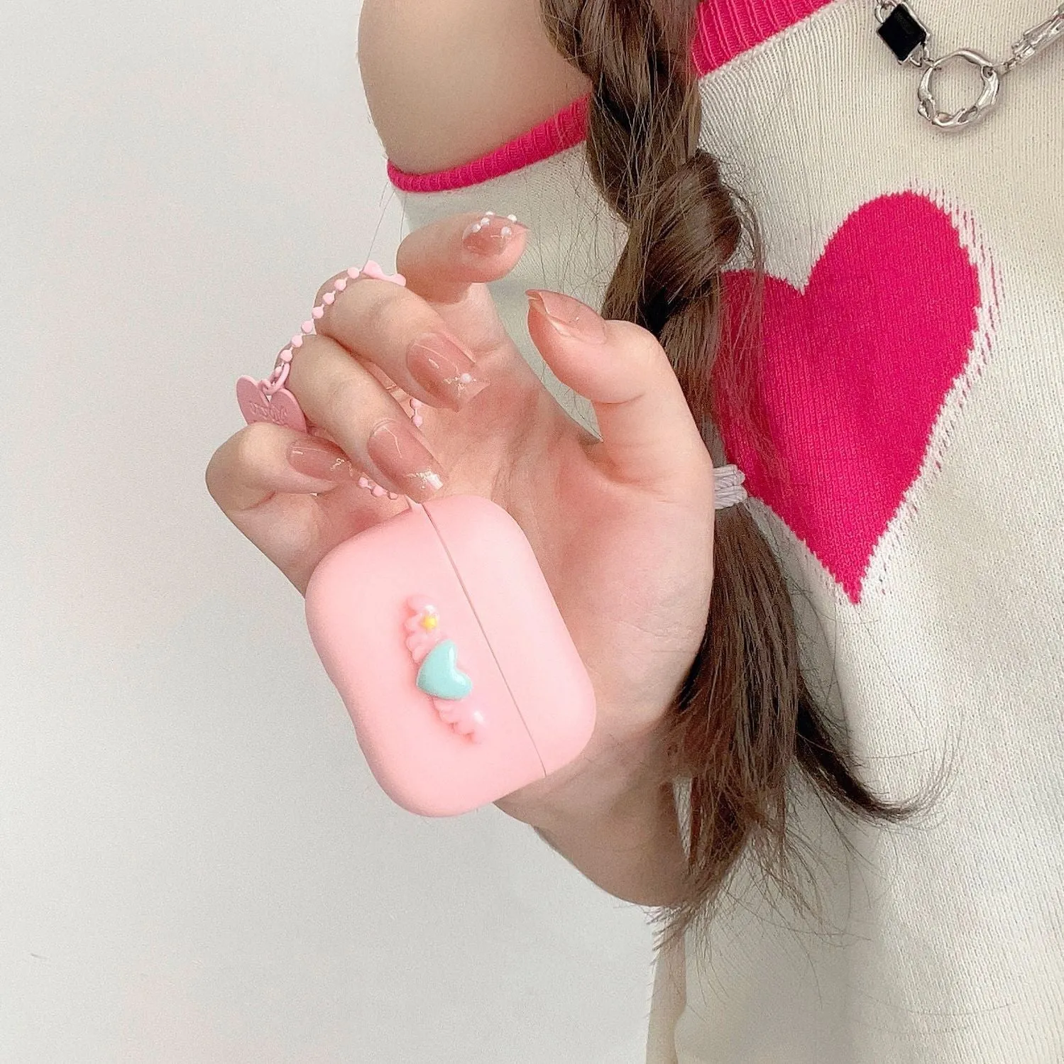 Heart Wings TPU protective case for AirPods with three-dimensional relief design in pink, purple, and yellow colours
