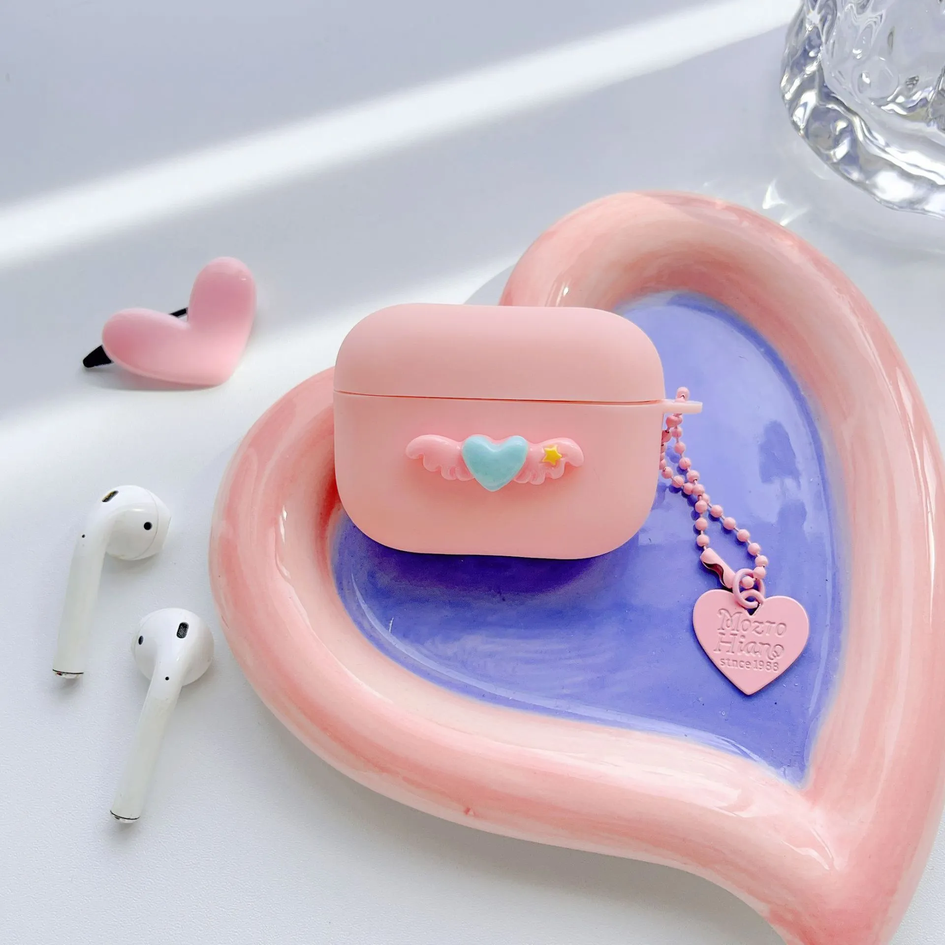 Heart Wings TPU protective case for AirPods with three-dimensional relief design in pink, purple, and yellow colours