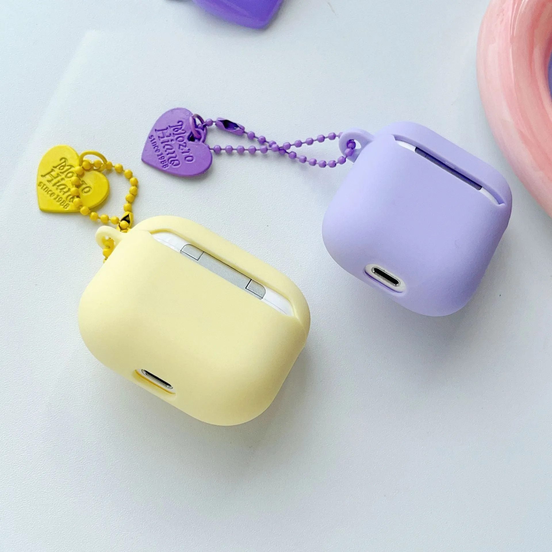 Heart Wings TPU protective case for AirPods with three-dimensional relief design in pink, purple, and yellow colours