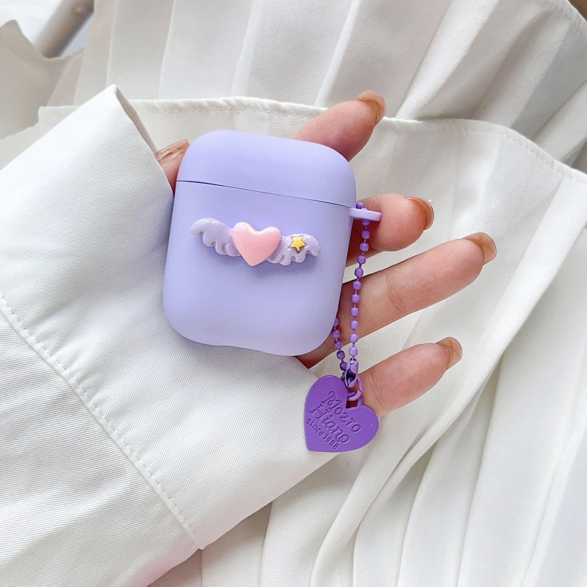 Heart Wings TPU protective case for AirPods with three-dimensional relief design in pink, purple, and yellow colours
