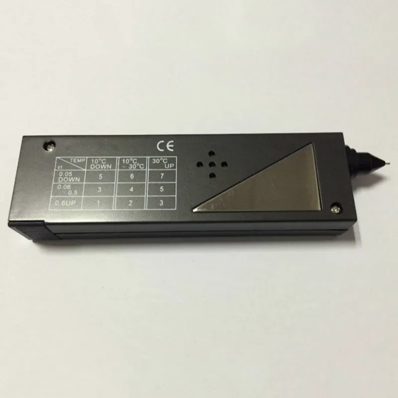 Black handheld diamond thermal conductivity meter with metal probe on a white background.